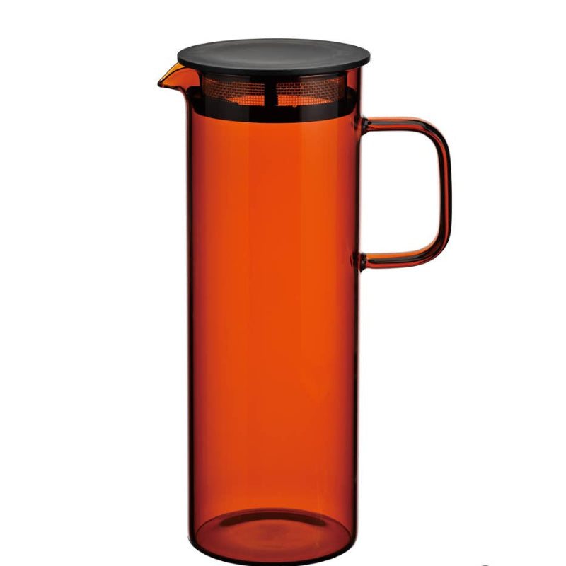 A heatproof orange glass cold brew pitcher with a lid and handle, designed for making cold beverages.