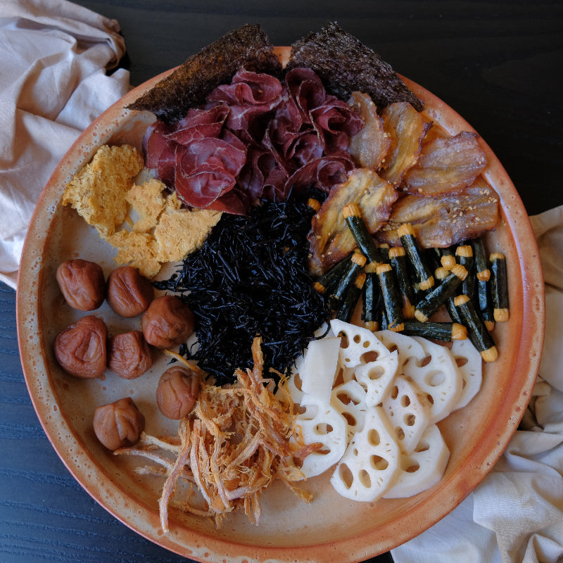 Plated dish with various food items on a dark surface