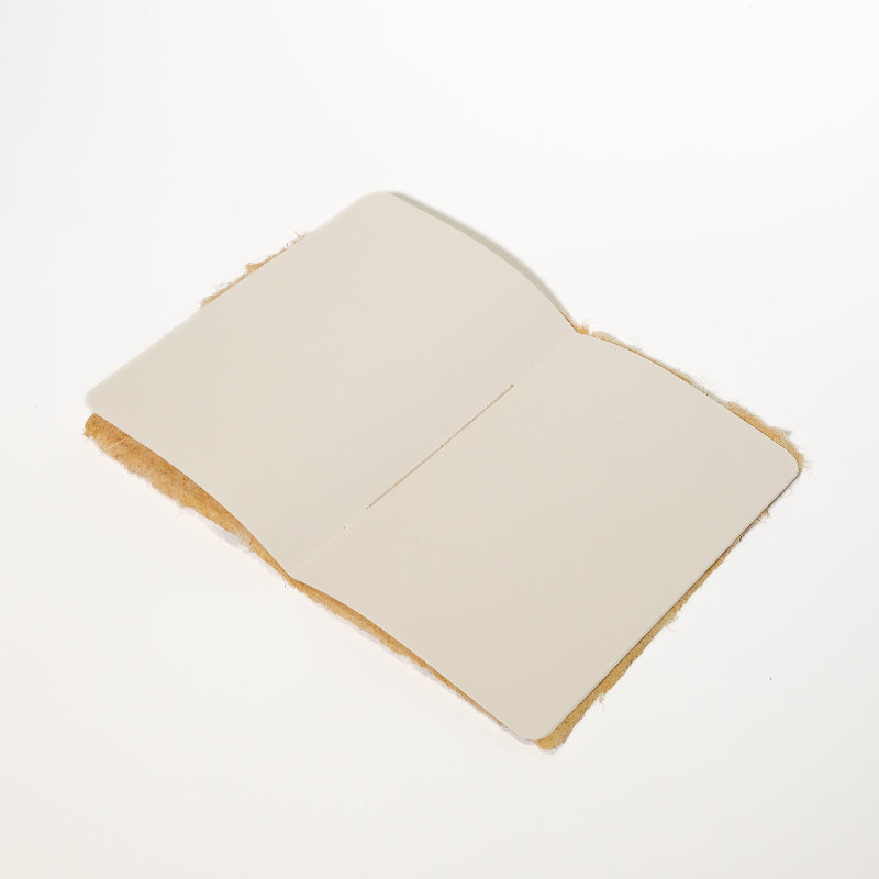 handmade lemongrass paper notebook, open and laying flat on white background