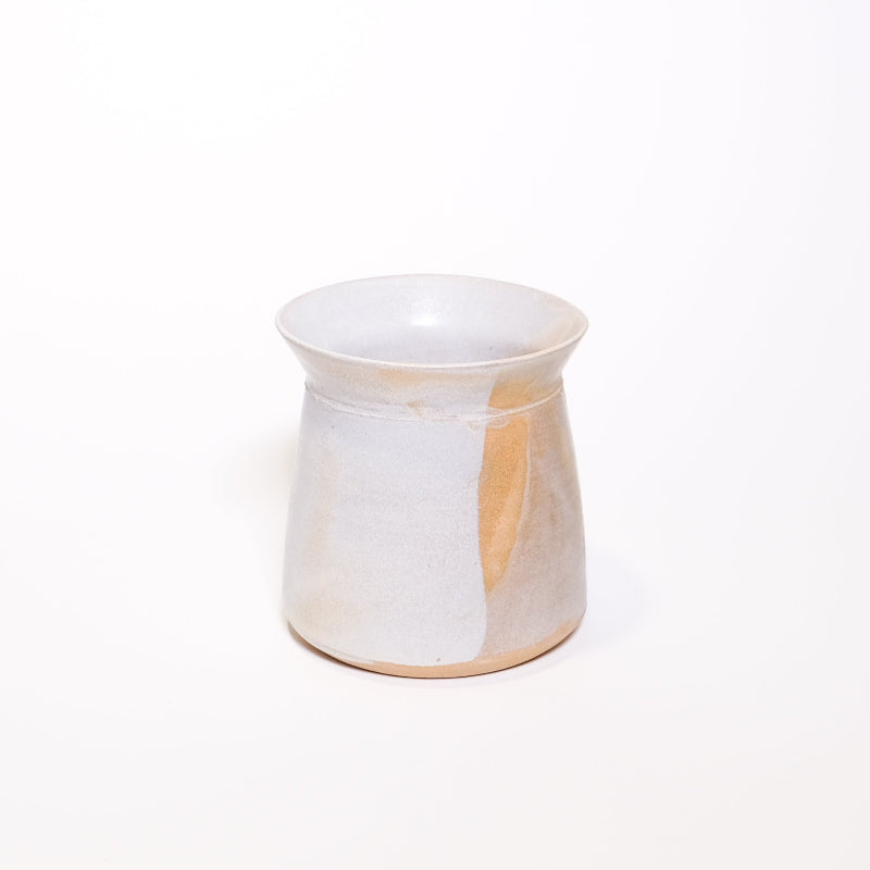 White ceramic vase with beige accents on a white background