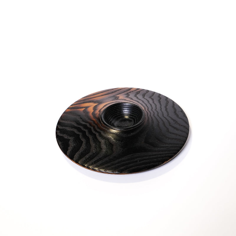 Charred black wooden ash bowl with a textured surface on a white background